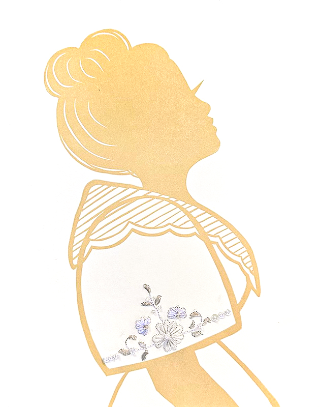 Silhouette of woman with hair pulled back, wearing a terno with embroidered sleeve.